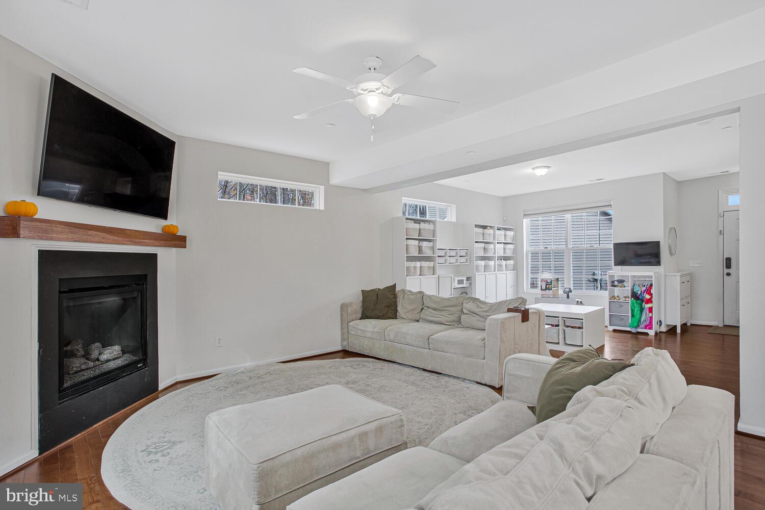 703 Trapper Way Deale, MD 20751 - Photo 2 of 18 a living room with furniture a flat screen tv and a fireplace