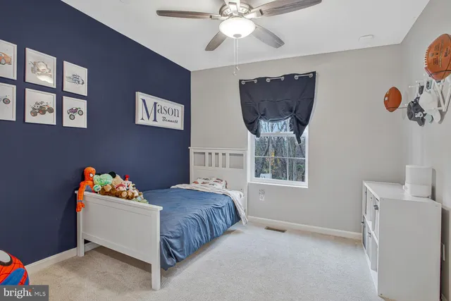 a bedroom with bed and window