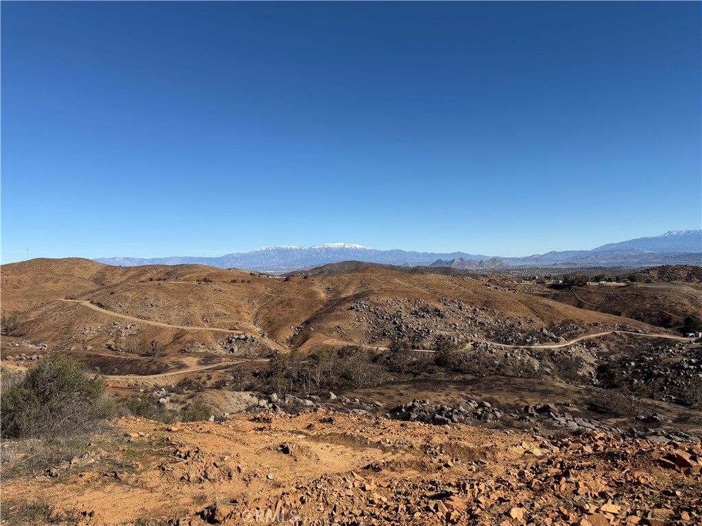 0 Blue Sky Road Perris, CA 92570 - Photo 1 of 14 a view of a mountain range in a cloudy sky
