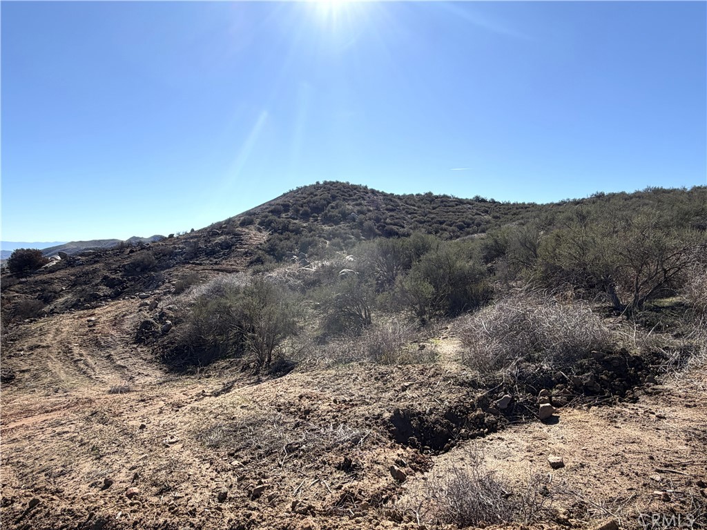 0 Blue Sky Road Perris, CA 92570 - Photo 4 of 14 a view of a dry yard with mountains in the background