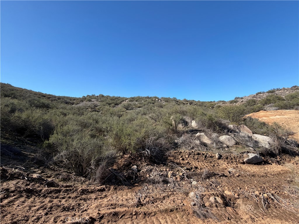 0 Blue Sky Road Perris, CA 92570 - Photo 9 of 14 a view of a dry yard with mountains in the background