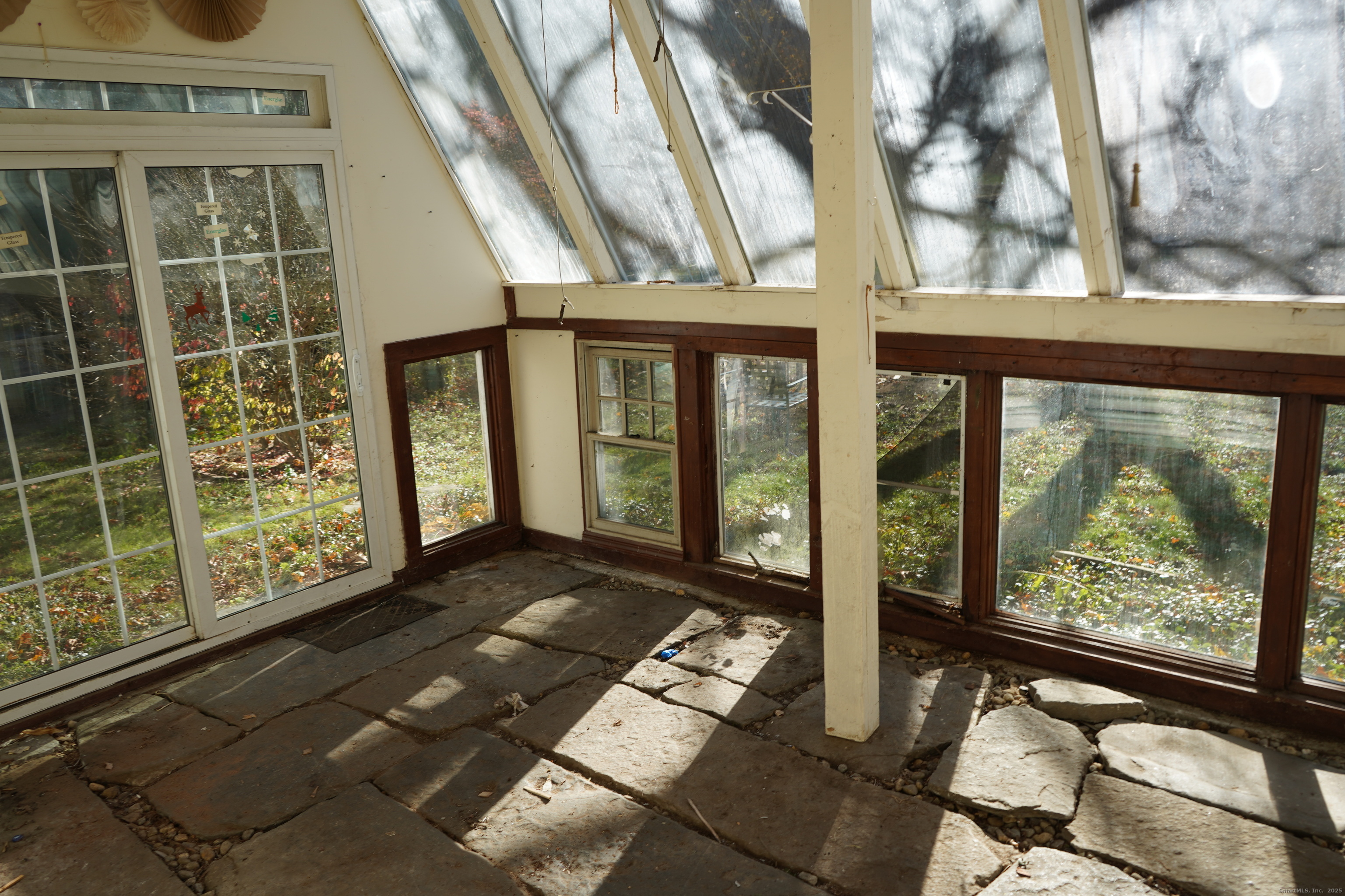 363 Windham Road Windham, CT 06226 - Photo 18 of 28 a view of a porch with chairs and floor to ceiling window