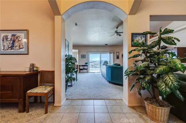 a living room with furniture and a ceiling fan