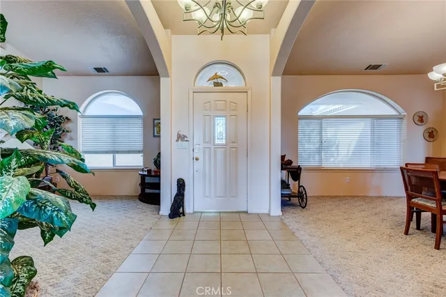 an entryway and livingroom with furniture
