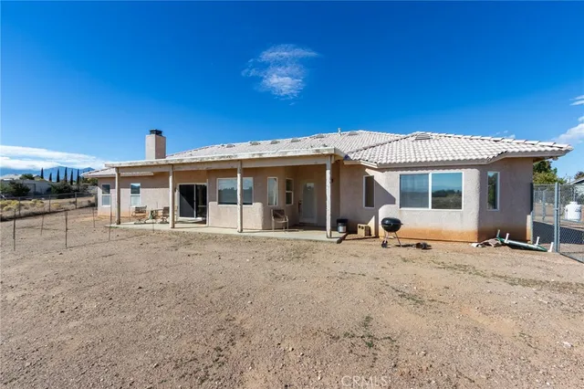 a living room with furniture a flat screen tv and a large window