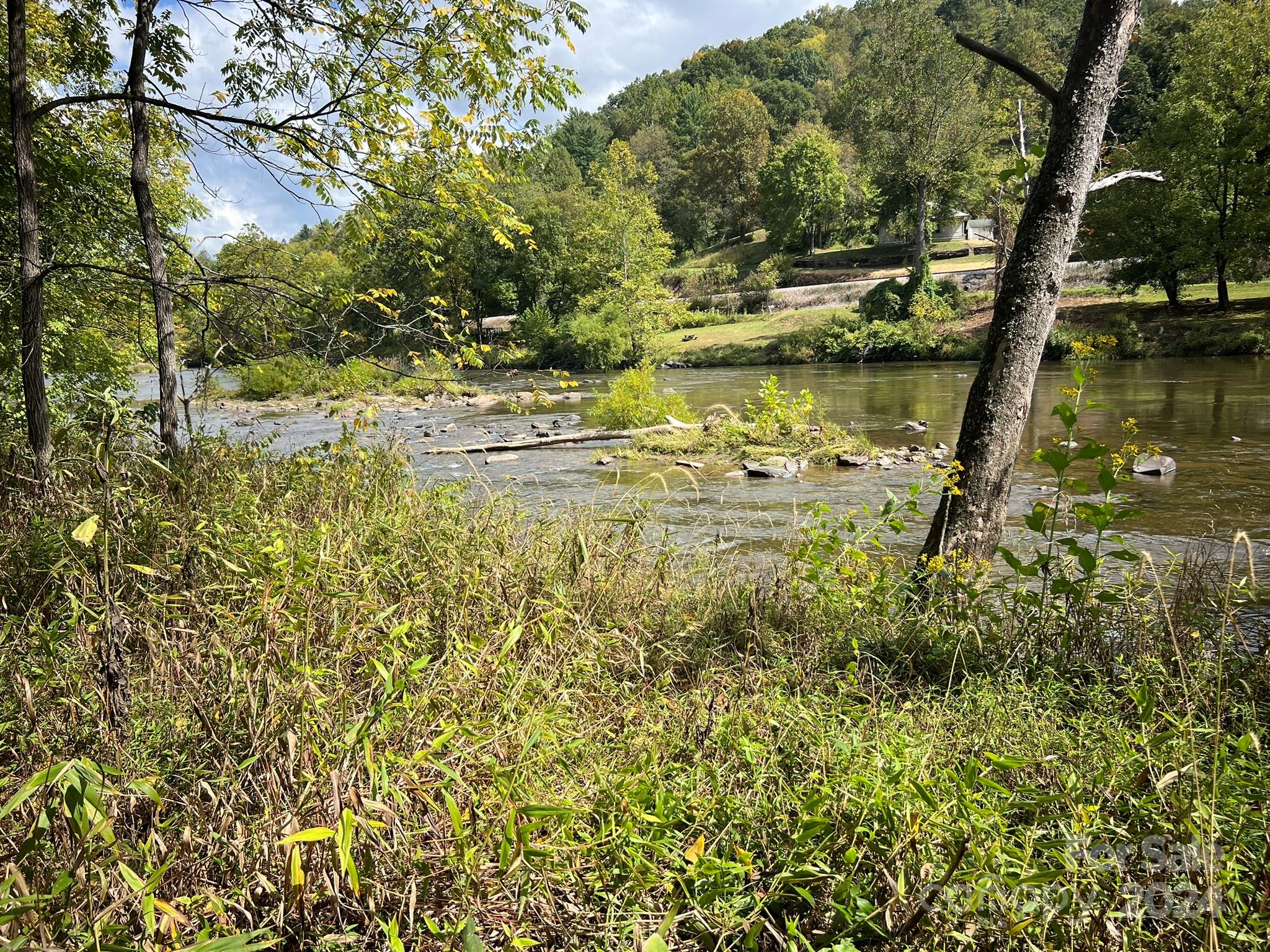 1471 Toe River Road Green Mountain, NC 28740 - Photo 12 of 44 a view of a lake with a house