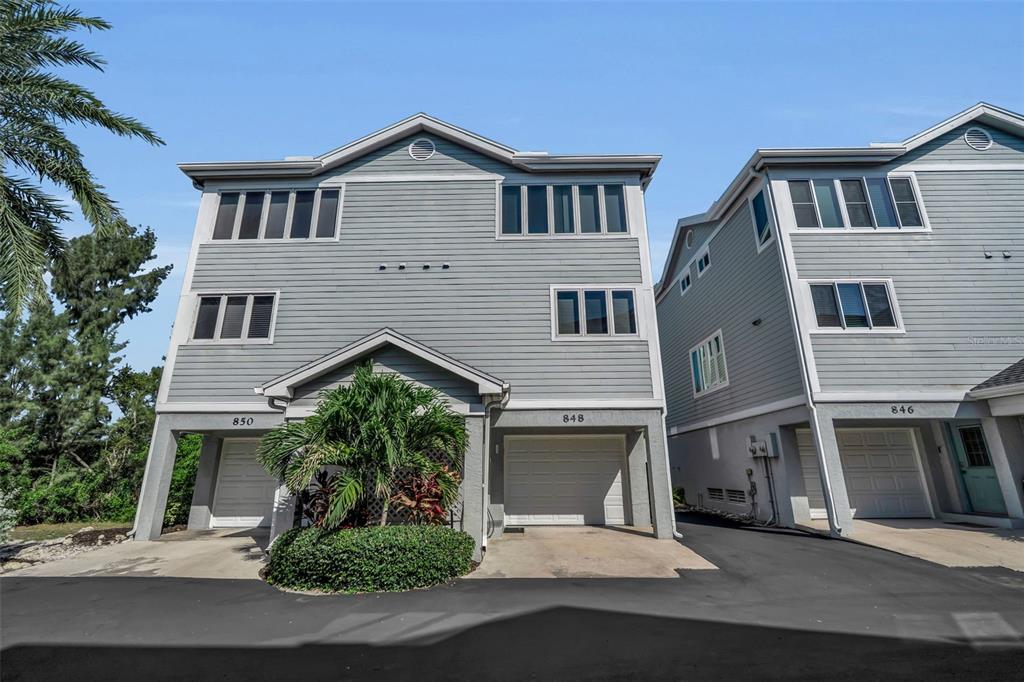 848 Evergreen Way Longboat Key, FL 34228 - Photo 1 of 66 a view of a white house next to a yard