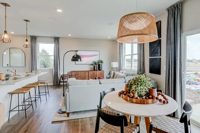 a living room with furniture a table and kitchen chandelier