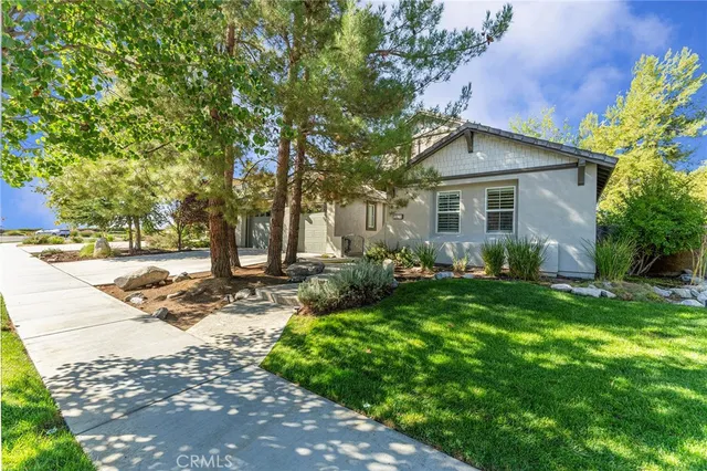 a view of a house with yard and tree s