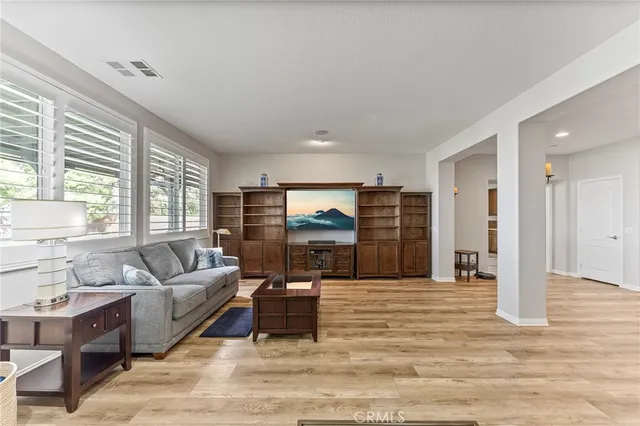 a view of a living room kitchen and a wooden floor