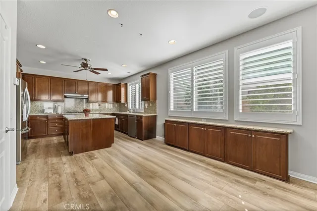 a kitchen with stainless steel appliances granite countertop a sink stove and microwave