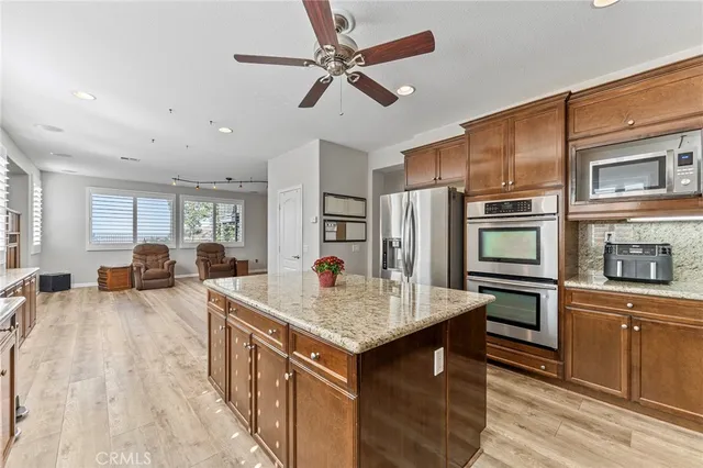 a view of a dining room with furniture a chandelier and wooden floor