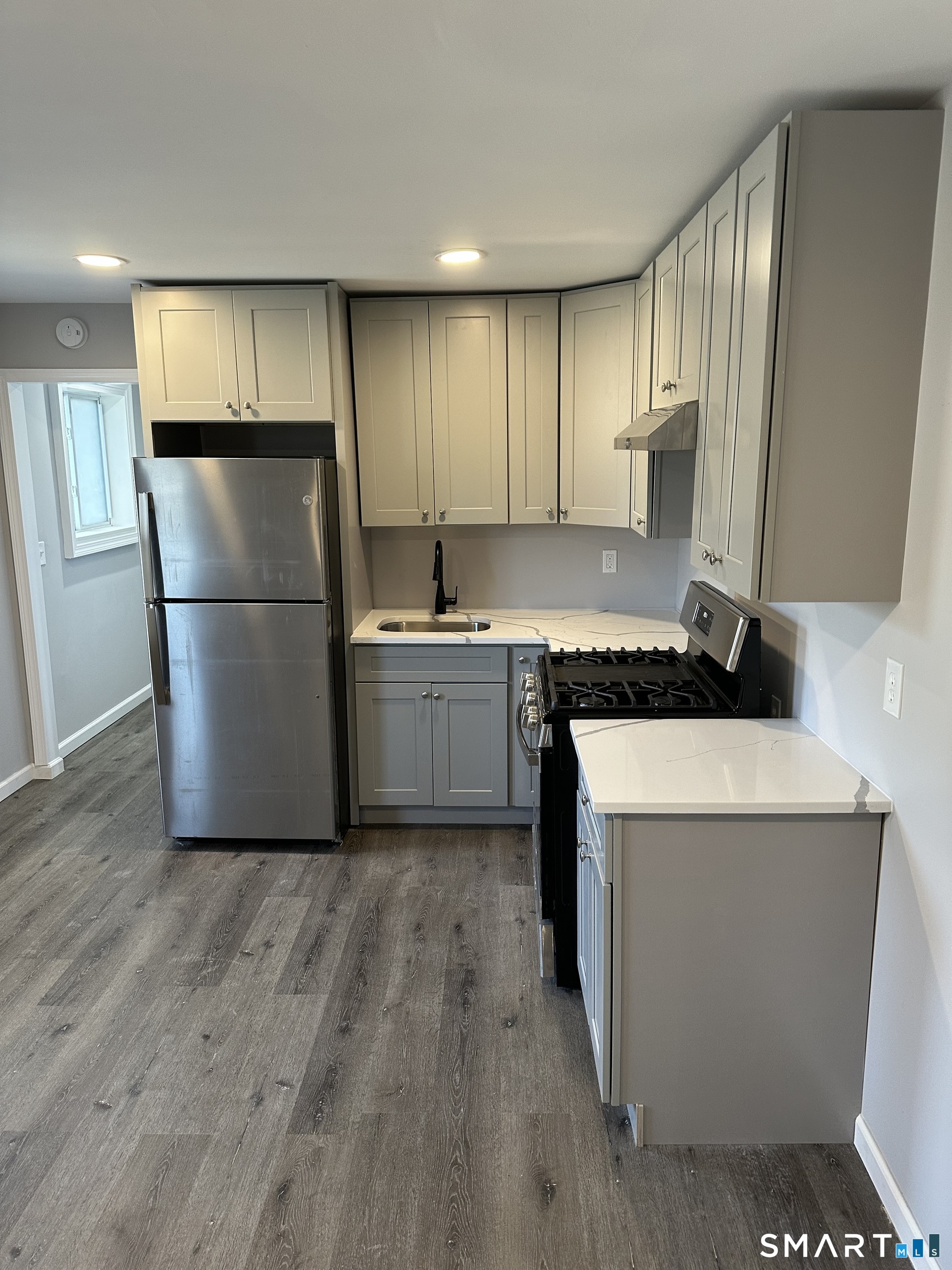 93 Culvert Street Torrington, CT 06790 - Photo 5 of 11 a kitchen with a refrigerator and a sink
