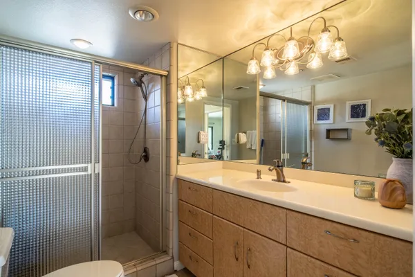 a bathroom with a sink and mirror with toilet