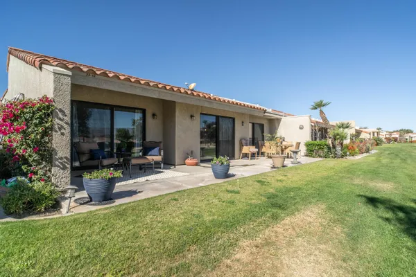 a view of a house with backyard porch and sitting area