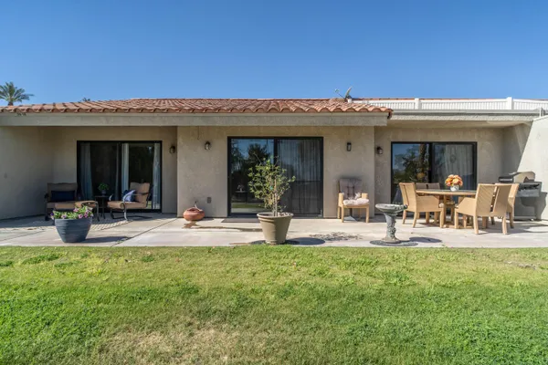 a view of a house with patio and sitting area