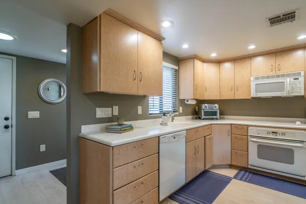 a kitchen with a sink dishwasher a stove and a refrigerator