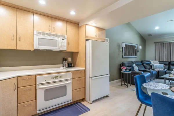a kitchen with refrigerator cabinets and furniture