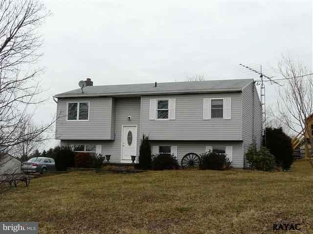 983 Richmond Road Windsor, PA 17366 - Photo 1 of 36 a front view of a house with a garden