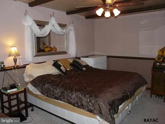 983 Richmond Road Windsor, PA 17366 - Photo 18 of 36 a bedroom with a bed mirror and lamp on dresser