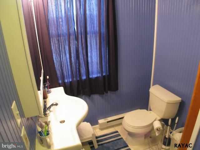 983 Richmond Road Windsor, PA 17366 - Photo 25 of 36 a white toilet sitting next to a wooden cabinet