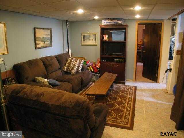 983 Richmond Road Windsor, PA 17366 - Photo 33 of 36 a living room with furniture and a flat screen tv