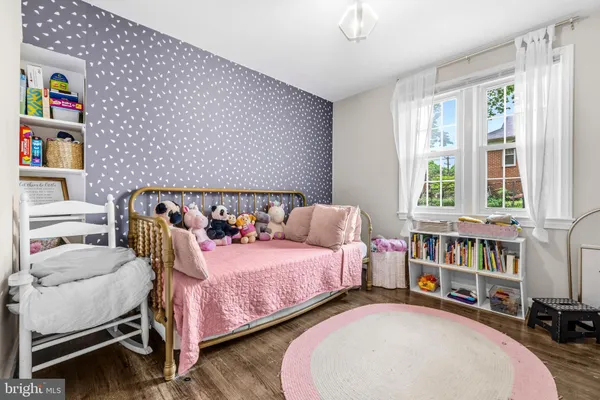 a bedroom with bed and a book shelf