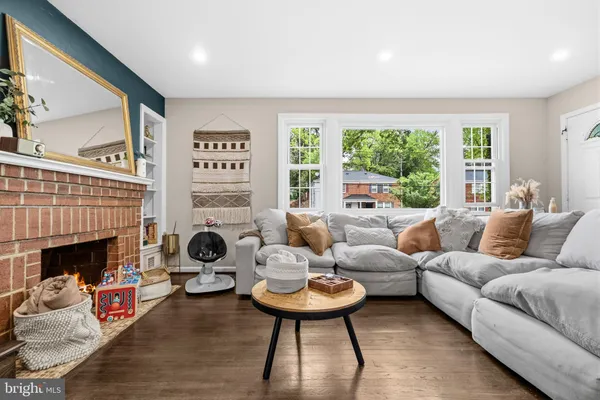 a living room with furniture a fireplace and a large window
