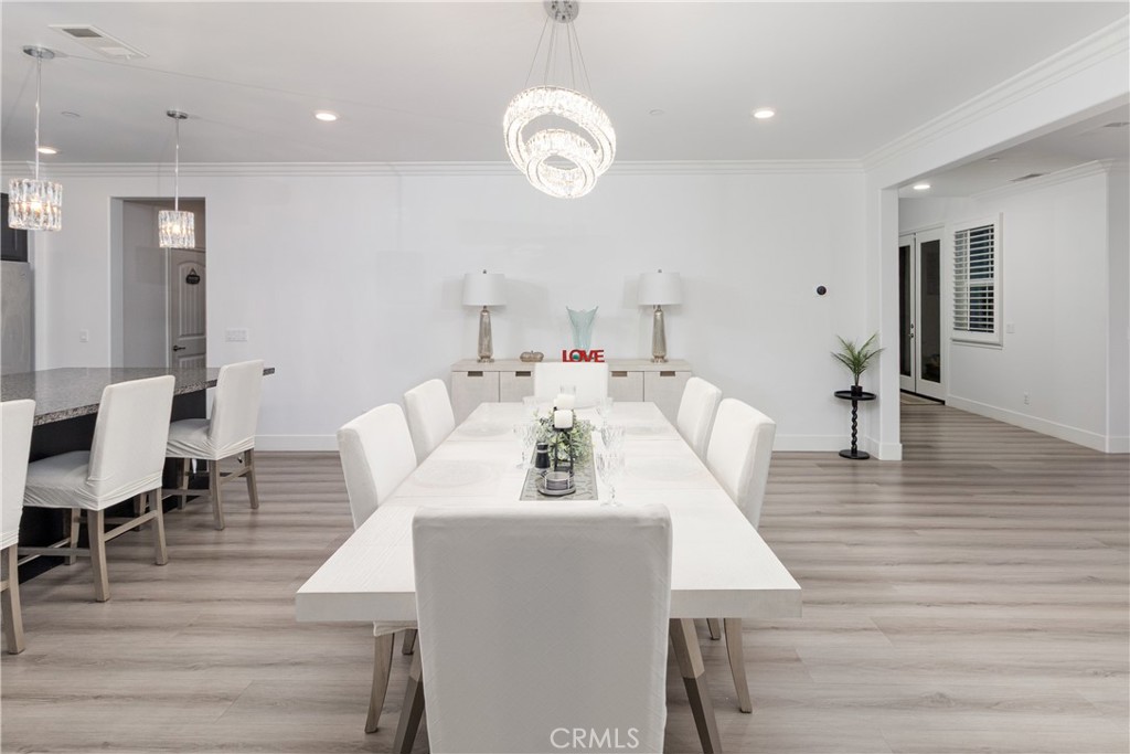 13866 Sweet Avenue Riverside, CA 92503 - Photo 11 of 69 a view of dining room and livingroom with furniture wooden floor a rug a fireplace