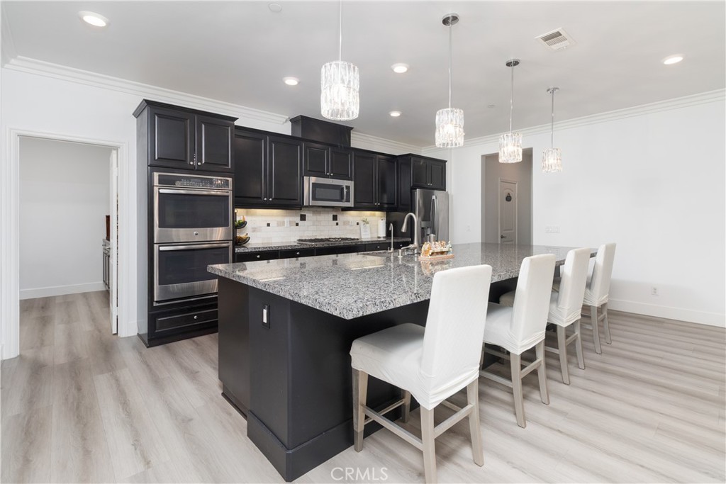 13866 Sweet Avenue Riverside, CA 92503 - Photo 12 of 69 a kitchen with cabinets and stainless steel appliances