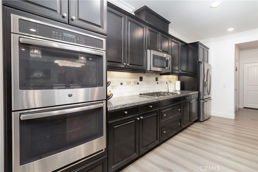 13866 Sweet Avenue Riverside, CA 92503 - Photo 14 of 69 a kitchen with stainless steel appliances and granite countertop cabinets