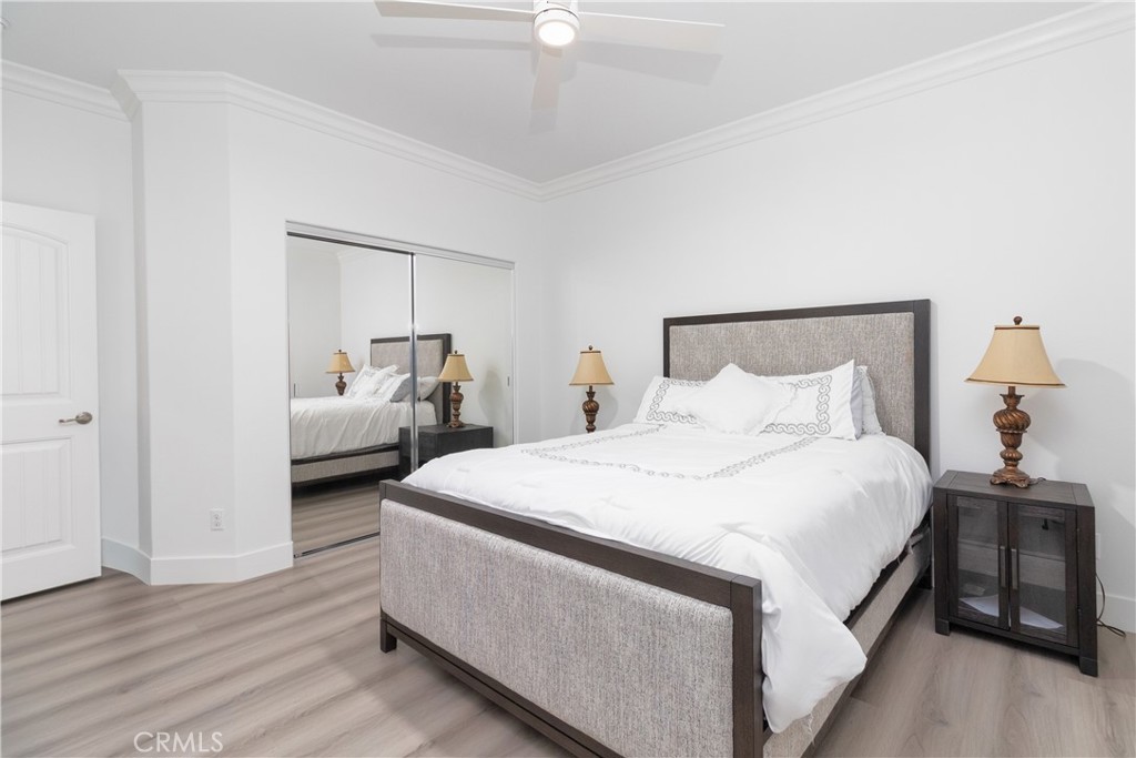 13866 Sweet Avenue Riverside, CA 92503 - Photo 23 of 69 a bed room with a bed and a chandelier