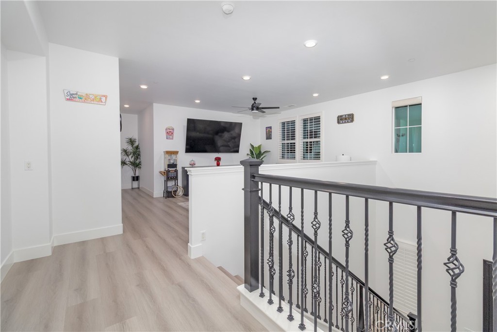 13866 Sweet Avenue Riverside, CA 92503 - Photo 25 of 69 a view of a livingroom with furniture a flat screen tv and staircase