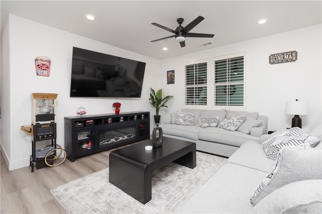 13866 Sweet Avenue Riverside, CA 92503 - Photo 26 of 69 a living room with furniture and a flat screen tv
