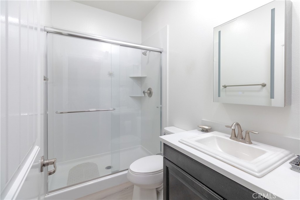 13866 Sweet Avenue Riverside, CA 92503 - Photo 31 of 69 a bathroom with a granite countertop sink toilet and shower