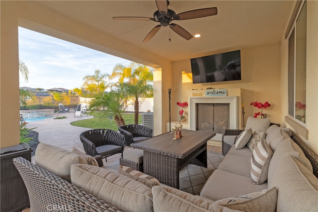 13866 Sweet Avenue Riverside, CA 92503 - Photo 41 of 69 a living room with furniture a fireplace and a flat screen tv