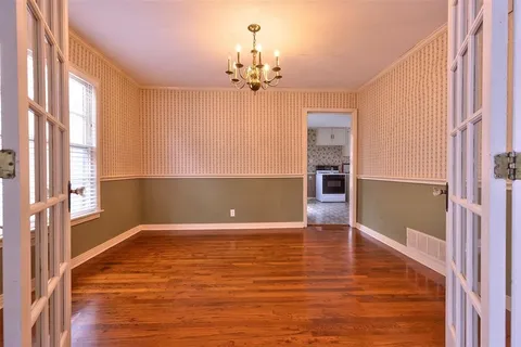 a view of a livingroom with a ceiling fan window and wooden floor