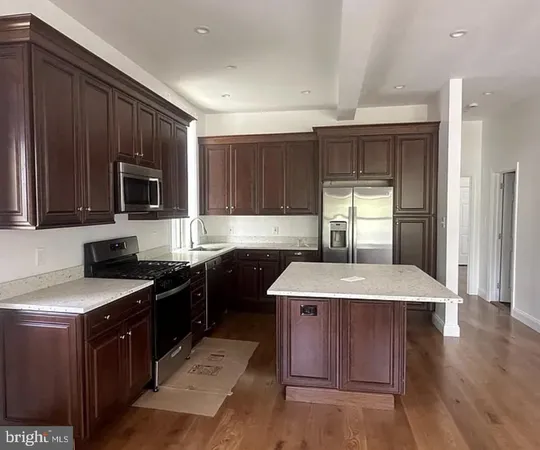 a kitchen with a stove sink and microwave