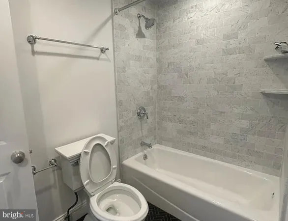 a bathroom with a sink a toilet and a bathtub