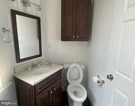 a bathroom with a sink toilet and mirror