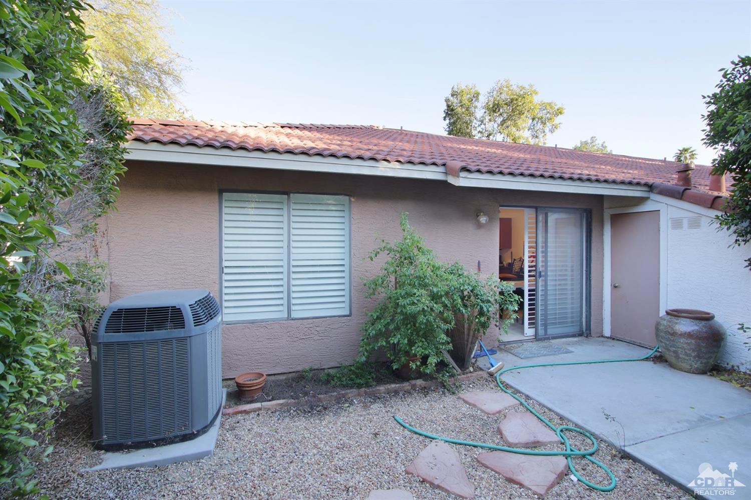 43376 Cook Street, Unit 96 Palm Desert, CA 92211 - Photo 12 of 29 a front view of a house with garden