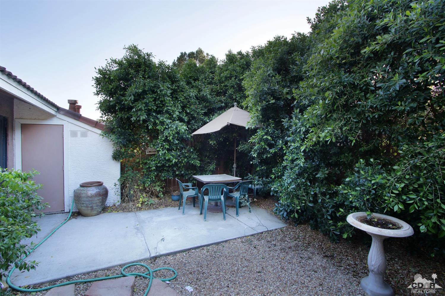 43376 Cook Street, Unit 96 Palm Desert, CA 92211 - Photo 14 of 29 a view of a patio with table and chairs and potted plants