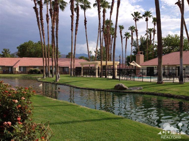 43376 Cook Street, Unit 96 Palm Desert, CA 92211 - Photo 19 of 29 a view of a lake with a big building