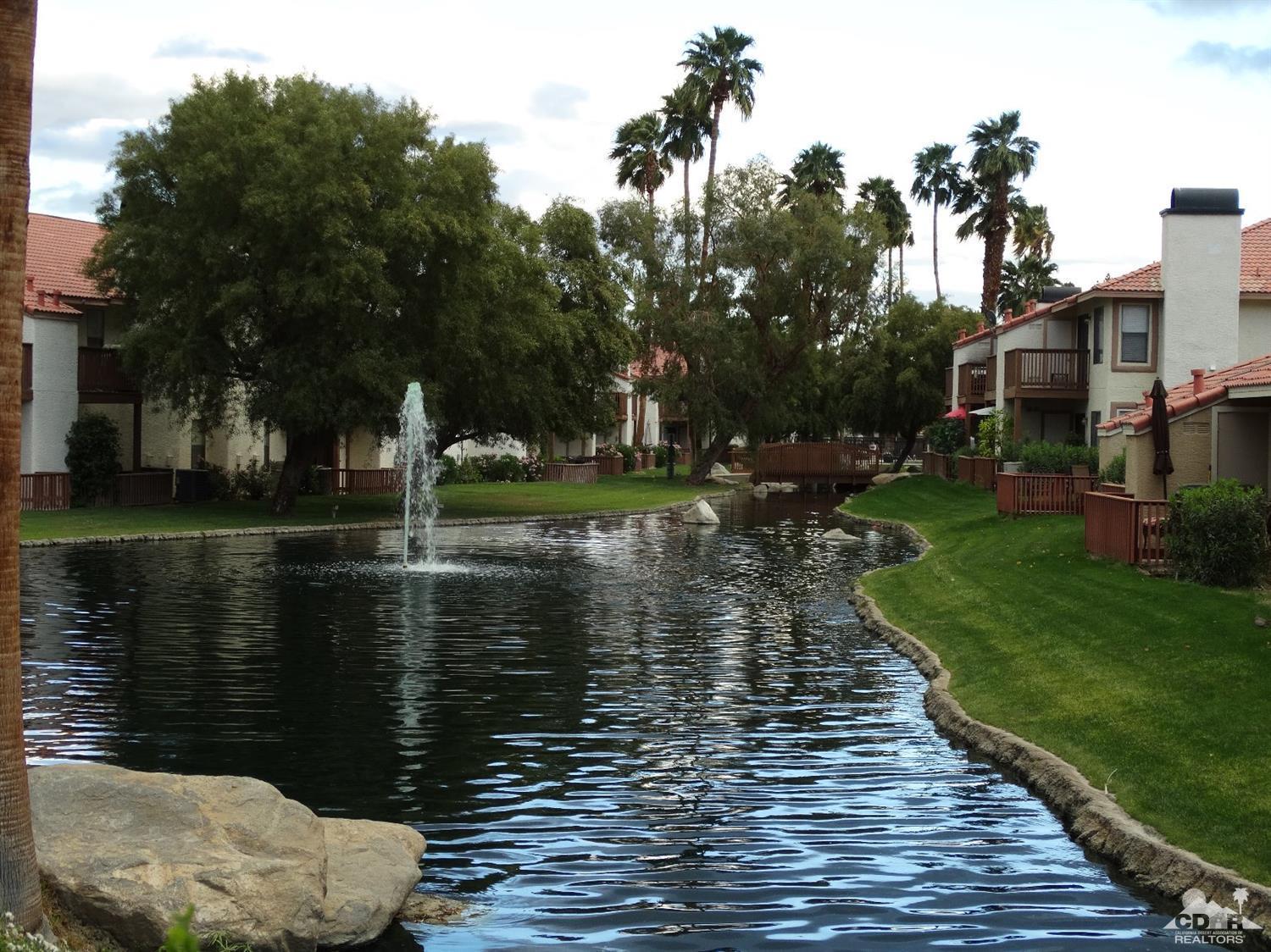 43376 Cook Street, Unit 96 Palm Desert, CA 92211 - Photo 20 of 29 a body of water with a tree in the background