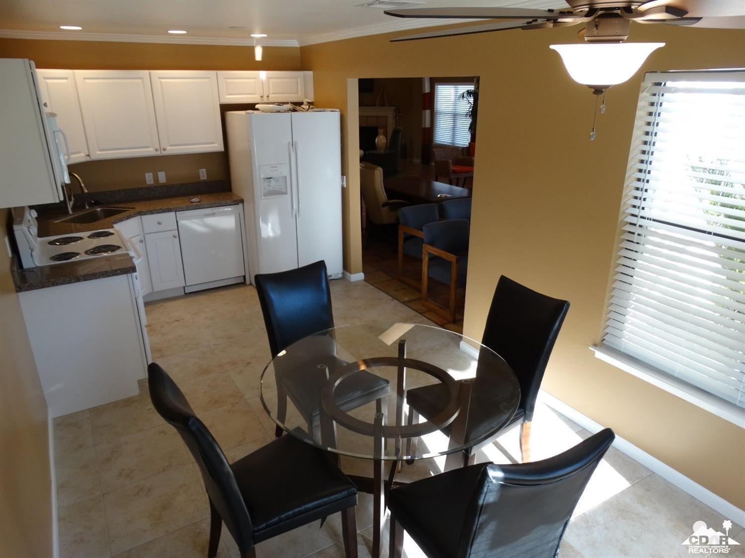 43376 Cook Street, Unit 96 Palm Desert, CA 92211 - Photo 23 of 29 a dining room with furniture and wooden floor