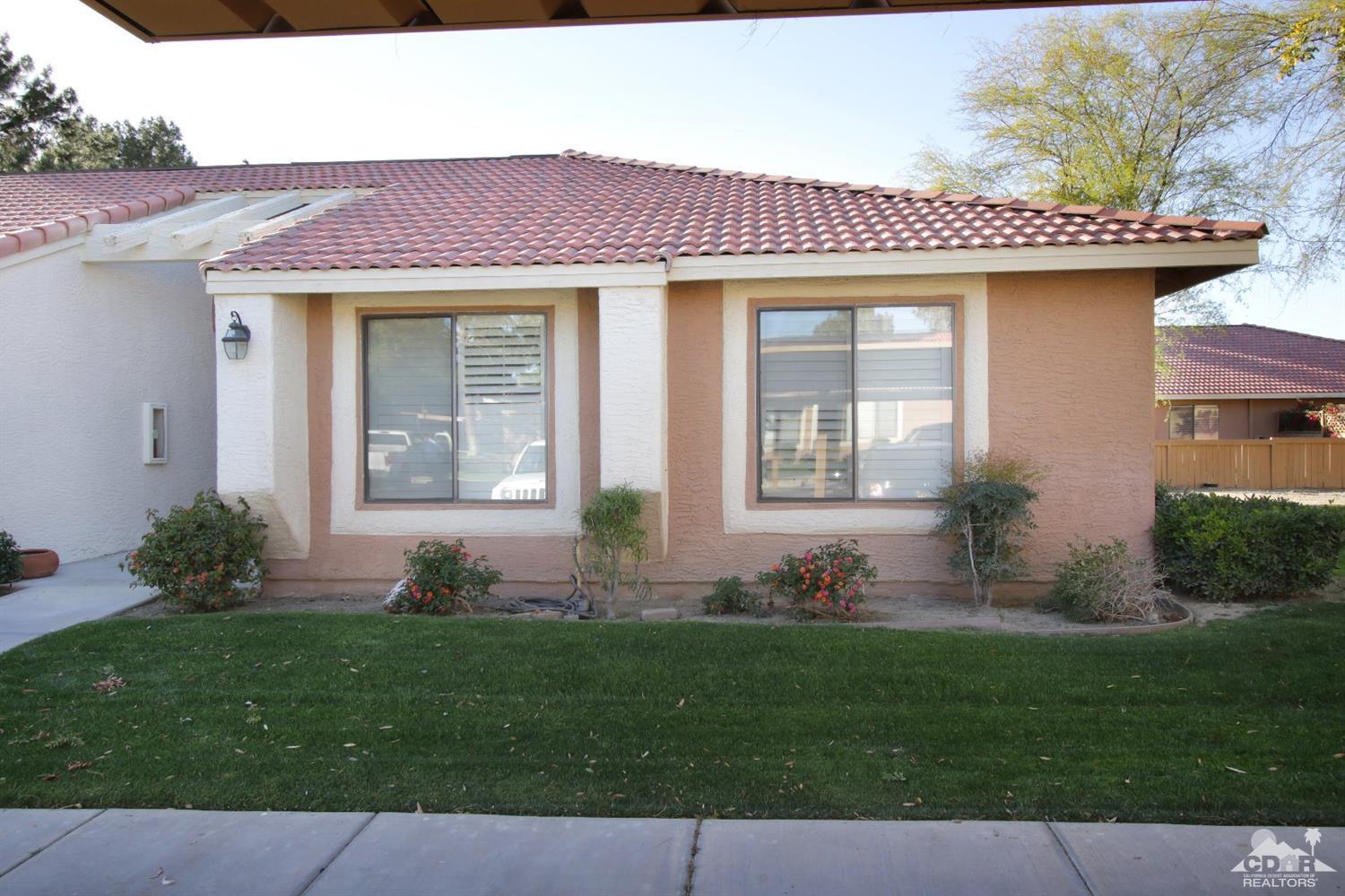 43376 Cook Street, Unit 96 Palm Desert, CA 92211 - Photo 28 of 29 a front view of a house with a garden