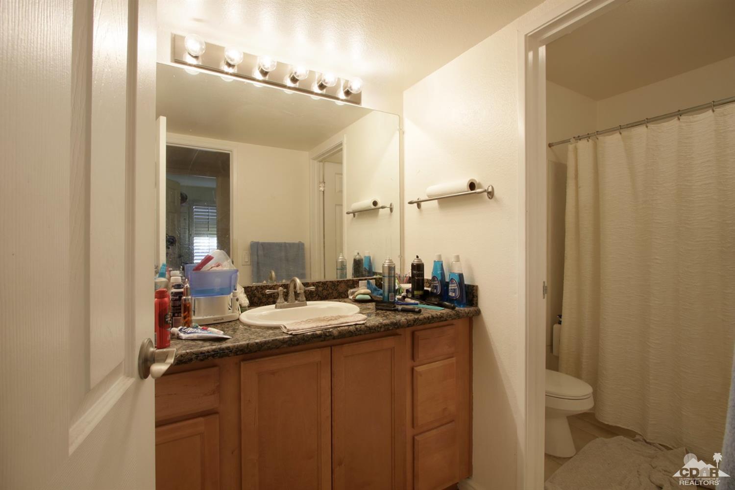 43376 Cook Street, Unit 96 Palm Desert, CA 92211 - Photo 9 of 29 a bathroom with a double vanity sink and a mirror