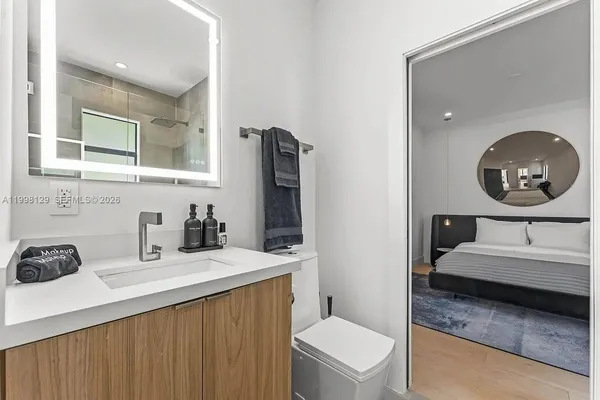 a bedroom with a bed and a flat screen tv