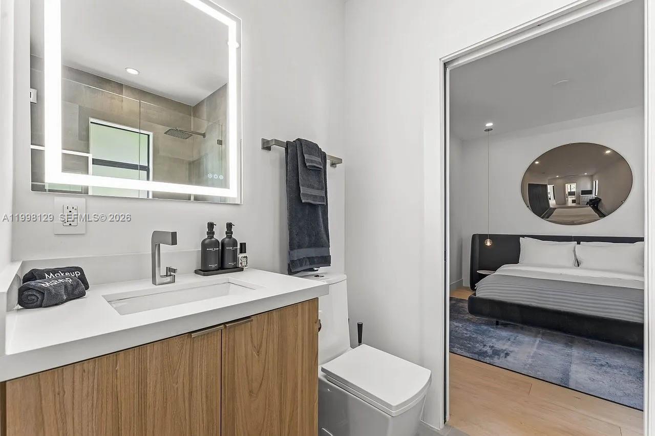445 Northeast 76th Street Miami, FL 33138 - Photo 16 of 63 a bathroom with a sink a toilet and a mirror