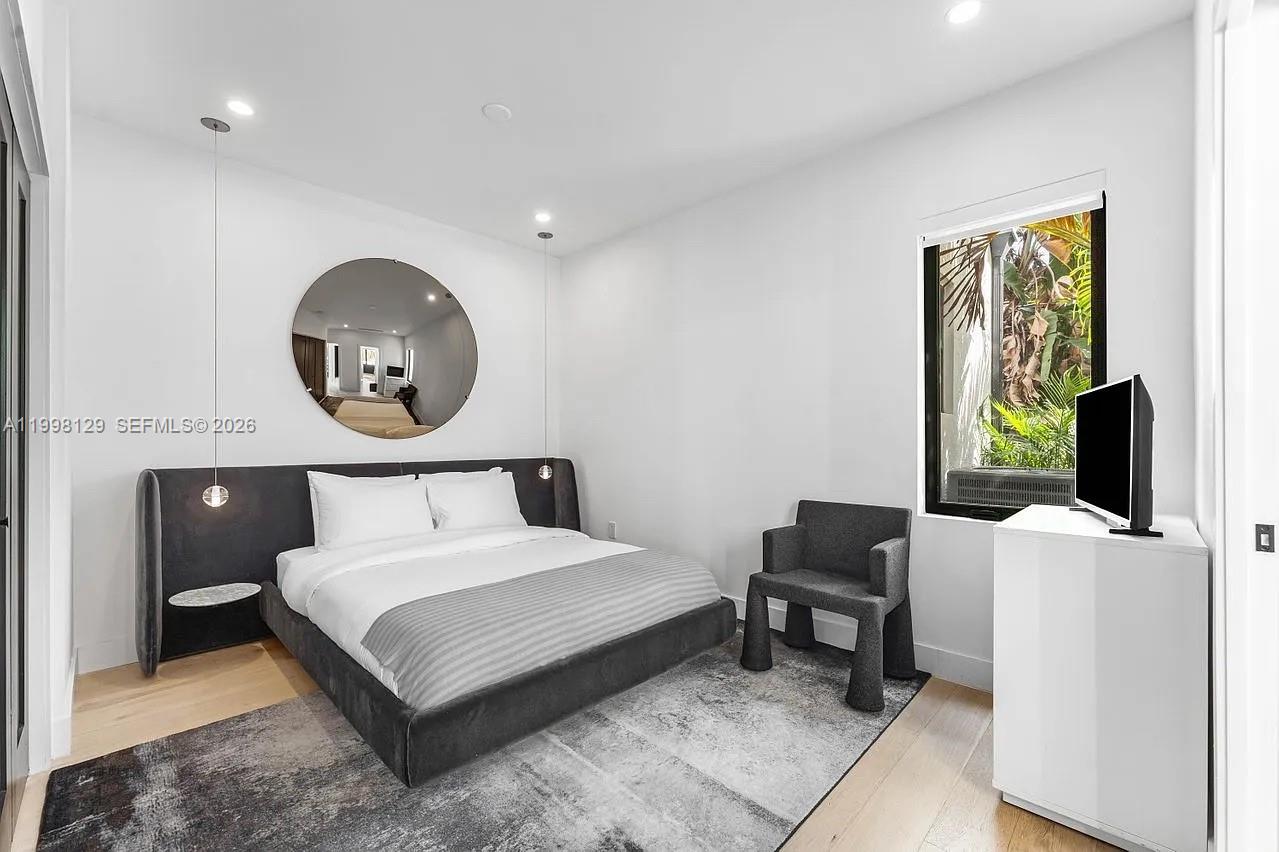 445 Northeast 76th Street Miami, FL 33138 - Photo 20 of 63 a bedroom with a bed and a flat screen tv